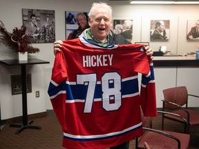 Montreal Gazette sports columnist Pat Hickey holds up a Montreal Canadiens jersey during a ceremony in his honour prior to covering his final Habs game in Montreal on Feb. 25, 2023.