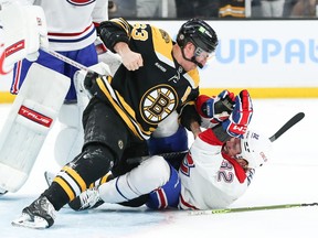 Boston Bruins left wing Brad Marchand (63) punches Montreal Canadiens centre Rem Pitlick (32) during the first period at TD Garden in Boston on Thursday, March 23, 2023.