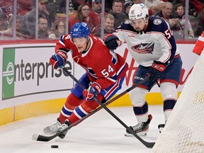 Canadiens defenceman Jordan Harris (54) plays the puck and Columbus Blue Jackets forward Emil Bemstrom (52) forechecks during the first period at the Bell Centre in Montreal on Saturday, March 25, 2023.
