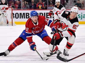 Canadiens' Rem Pitlick (32) and New Jersey Devils forward Jesper Bratt (63) battle for the puck during the first period at the Bell Centre  on Saturday, MArch 11, 2023, in Montreal.