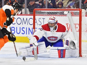 Montreal Canadiens goaltender Cayden Primeau (30) pokes the puck away from Philadelphia Flyers left wing Noah Cates (49) during the second period at Wells Fargo Center in Philadelphia on Tuesday, March 28, 2023.