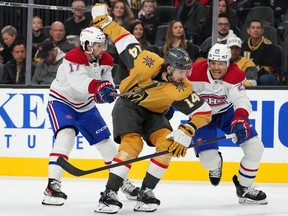 Vegas Golden Knights defenceman Nicolas Hague (14) attempts to skate between Canadiens' Josh Anderson (17) and Johnathan Kovacevic (26) during the first period at T-Mobile Arena on Sunday, March 5, 2023, in Las Vegas.