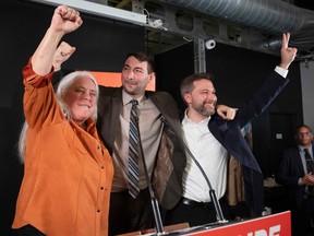 Québec solidaire's Guillaume Cliche-Rivard, centre, celebrates his byelection victory  with party co-spokespeople Manon Massé and Gabriel Nadeau-Dubois in Montreal on Monday, March 13, 2023.