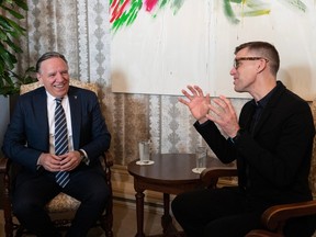 Quebec Premier François Legault, left, and Quebec City mayor Bruno Marchand chat at a ceremony, at city hall, in Quebec City, Thursday, March 2, 2023. Legault was made honorary mayor of Quebec City.