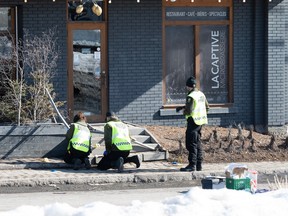 Police officers investigate the scene of a fatal incident, Tuesday, March 14, 2023  in Amqui Que. Two people were killed and nine others were injured Monday afternoon when a pickup truck plowed into pedestrians who were walking beside a road in the eastern Quebec town of Amqui.