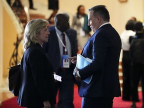 Quebec Premier François Legault speaks to his Minister of Foreign Relations and of the Francophonie, Martine Biron, as they take part in the Francophonie Summit in Djerba, Tunisia on Sunday, Nov. 20, 2022. The Quebec government has come under fire for funding a women's group accused of allegedly spreading transphobic views and even going so far as targeting trans activists online.