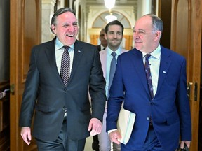 Quebec Premier François Legault, left, walks to a cabinet meeting with Quebec Health Minister Christian Dubé who tabled a major legislation on health, at the legislature in Quebec City, Wednesday, March 29, 2023.