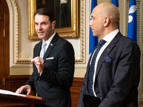 Quebec Minister of Public Security François Bonnardel, flanked by Quebec Minister Responsible for the Fight Against Racism Christopher Skeete, introduces a bill on policing practices during a news conference, Wednesday, March 15, 2023 at the legislature in Quebec City.