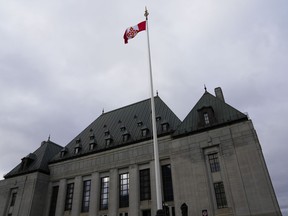 The flag of the Supreme Court of Canada flies on the east flag pole.