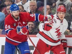 Canadiens defenceman Joel Edmundson jostles with Hurricanes' Jesper Fast during a game at the Bell Centre last month.
