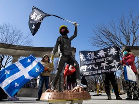 A group of people from Action Free Hong Kong Montreal protest against the possibility the Chinese government runs two unofficial police stations in Montreal. The group gathered at the Roddick Gates in Montreal on Sunday, April 2, 2023.