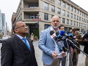 Ensemble Montréal councillors Alan DeSousa, left, and Aref Salem hold a news conference about the city's building permit and inspection processes outside a hotel in Old Montreal on Monday April 3, 2023.