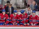 Canadiens head coach Martin St-Louis talks with captain Nick Suzuki  on the bench during Tuesday night's 5-0 loss against the Red Wings at the Bell Centre. 