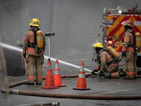 Montreal firefighters douse the flames at a residential building on  Dezery St. Several homes were evacuated.