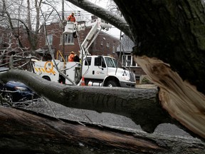 Hydro-Québec work to take down a fallen power line after hit was hit by a falling tree on Wilson Avenue near Notre-Dame-de Grâce Avenue in N.D.G. on Wednesday April 5, 2023 as freezing falls on the city.