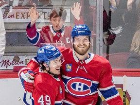 A young Habs fan looks on as Canadiens' Rafael Harvey-Pinard, left, congratulated teammate Joel Armia on his hat-trick goal Thursday night at the Bell Centre.