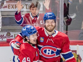 A Habs fan had a front row seat to watch Montreal Canadiens left wing Rafael Harvey-Pinard (49) congratulate Montreal Canadiens right wing Joel Armia (40) on his hat trick goal against the Washington Capitals during 3rd period NHL action at the Bell Centre in Montreal on Thursday April 6, 2023.