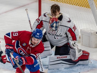 Washington Capitals goaltender Darcy Kuemper's (35) mask falls off after taking a puck to the head with Montreal Canadiens left wing Rafael Harvey-Pinard (49) looking for the rebound during 2nd period NHL action at the Bell Centre in Montreal on Thursday April 6, 2023.