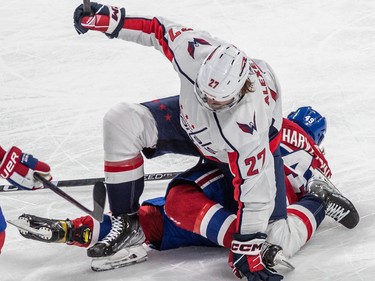 Montreal Canadiens left wing Rafael Harvey-Pinard (49) and Washington Capitals defenceman Alexander Alexeyev (27) get tangled up during 2nd period NHL action at the Bell Centre in Montreal on Thursday April 6, 2023.