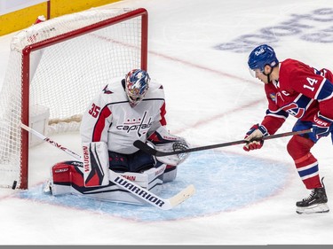 Montreal Canadiens center Nick Suzuki (14) and Washington Capitals goaltender Darcy Kuemper (35) watch the puck head into the corner during 1st period NHL action at the Bell Centre in Montreal on Thursday April 6, 2023.