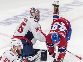 Montreal Canadiens left wing Rafael Harvey-Pinard (49) is checked by Washington Capitals goaltender Darcy Kuemper (35) during 1st period NHL action at the Bell Centre in Montreal on Thursday April 6, 2023.