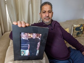 Mustapha Ouahdi holds a photo showing him with his son Hani, who was killed at the age of 20 a year and a half ago.