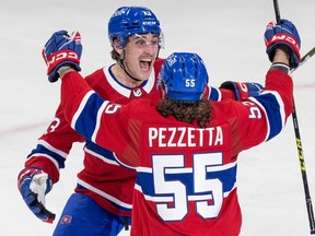MONTREAL, QUE.: \April\  13, 2023 -- Montreal Canadiens Lucas Condotta celebrates his first NHL goal with Michael Pezzetta during first period of National Hockey League game against the Boston Bruins in Montreal Thursday April 13, 2023.