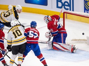 Boston Bruins' Charlie Coyle shoots the puck past Montreal Canadiens' Sam Montembault in Montreal April 13, 2023.