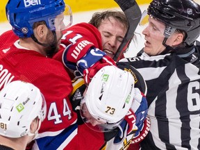 Canadiens' Brendan Gallagher throws a punch at Bruins' Charlie McAvoy during a scrum in front of the Boston net last week.