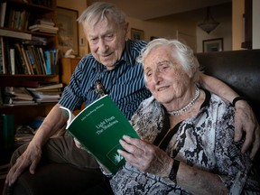 Mila Sandberg-Mesner and her husband, Isadore Mesner, go through her book that recounts her ordeal during the Holocaust from her home in Montreal on April 4, 2023.
