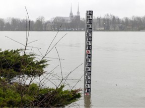A measuring gauge sticks out of the Rivière des Prairies in the Montreal borough of Île-Bizard—Ste-Geneviève on Monday April 17, 2023.