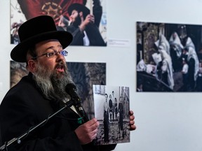 Mayer Feig, a member of the Council of Hasidic Jews of Quebec, speaks at the opening of an exhibition of photographs depicting the lives of Hasidic Jews. This family photograph depicts his paternal grandfather with his wife and their three children. Only his grandfather survived.
