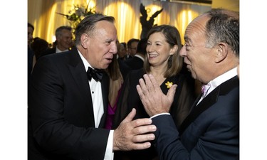 Quebec Premier François  Legault jokes with Health Minister Christian Dubé alongside Andrea Seale, CEO of the Canadian Cancer Society, during the Daffodil Ball in Montreal April 20, 2023.