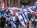 Marchers commemorate the 75th anniversary of the founding of the state of Israel, Wednesday April 26, 2023 on René-Lévesque Blvd. in Montreal.