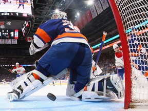 Canadiens' Nick Suzuki, right, scores a shorthanded goal against Ilya Sorokin of the New York Islanders during the second period at the UBS Arena on April 12, 2023 in Elmont, New York.