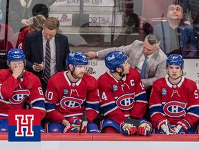 Montreal Canadiens head coach Martin St-Louis and Montreal Canadiens center Nick Suzuki (14) chat on the bench during 3rd period NHL action at the Bell Centre in Montreal on Tuesday April 4, 2023.