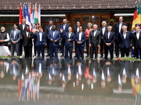 Members of the G7 and others pose tieless for a photo on June 27, 2022 at Elmau Castle, southern Germany, during the 48th G7 Summit.