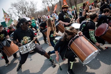 Drummers play as protesters march during the Earth Day Protest on April 22, 2023, in Montreal.