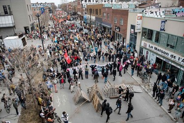 Black Bloc puts up a barricade as protesters march during the Earth Day Protest on April 22, 2023, in Montreal.
