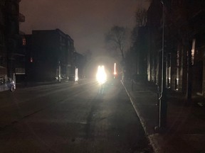 An eerie looking Bernard Ave. on the night of Thursday, April 6, 2023, in Outremont, where only the headlights of cars pierced the darkness.