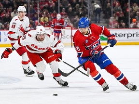 Canadiens defenceman Johnathan Kovacevic (26) plays the puck against Carolina Hurricanes' Stefan Noesen (23) during the first period at the Bell Centre in Montreal on Saturday, April 1, 2023.