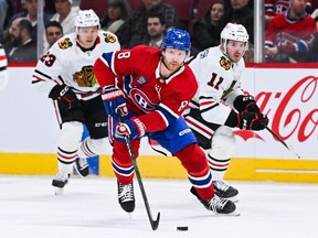 Canadiens defenceman Mike Matheson pulls away from two Blackhawks players during a February game at the Bell Centre.