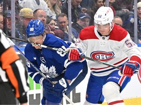 Canadiens defenceman Justin Barron (52) high sticks Maple Leafs forward William Nylander (88) and earns a two-minute penalty in the first period at Scotiabank Arena in Toronto on Saturday, April 8, 2023.