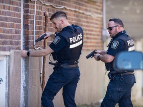 Police search apartment buildings around the Lachine Hospital after unconfirmed reports of a gunman in the area on Thursday April 13, 2023.