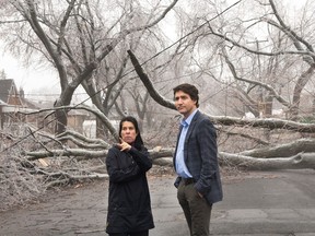 Prime Minister Justin Trudeau and Montreal Mayor Valérie Plante look at the damage after Wednesday's ice storm, which left more than a million Quebec customers without power, in Montreal, Thursday, April 6, 2023.