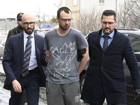 Steeve Gagnon is escorted by police into court in Amqui March 14, 2023. The Quebec man was charged after a pickup truck crashed into pedestrians.