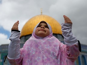 A child prays as Palestinian Muslims attend Friday prayers of the Muslim during Ramadan at the Noble Sanctuary.