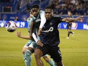 New York Red Bulls defender Andres Reyes ties up CF Montréal forward Chinonso Offor during first-half action at Saputo Stadium last week.