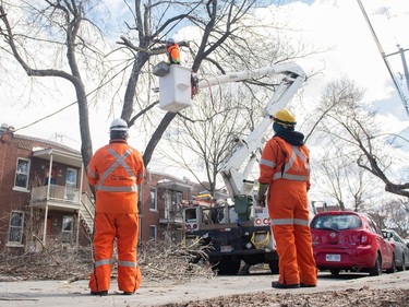 A Hydro crew works on a power line in Montreal April 7, 2023, two days after an an ice storm whipped across Quebec.