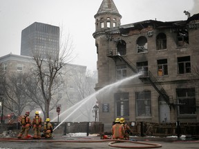 Montreal firefighters battle a blaze in Old Montreal on March 16 that ultimately killed seven people.